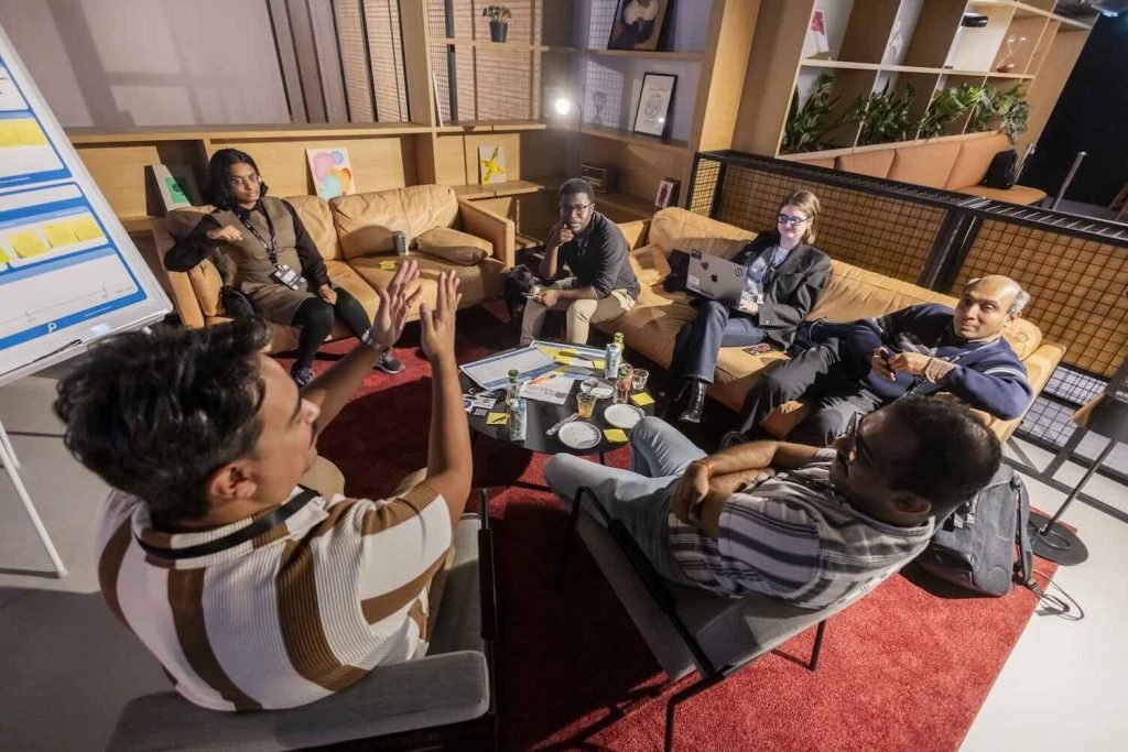 Photo of group discussing research proposal at PIMF Spain 2025