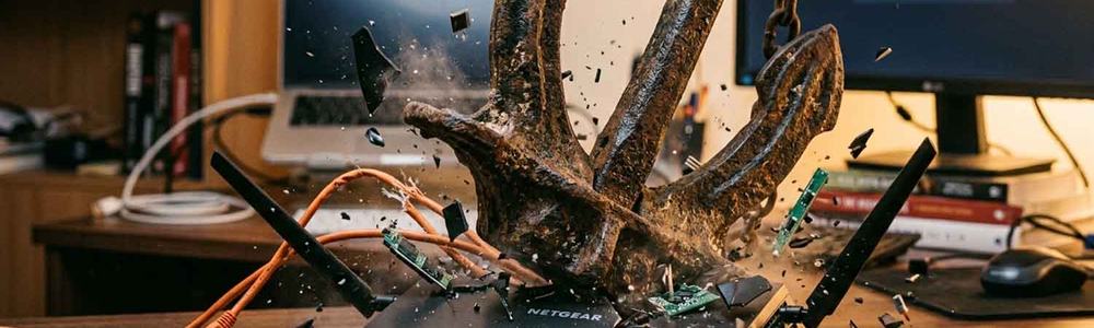 Photo of a home router being smashed by an anchor