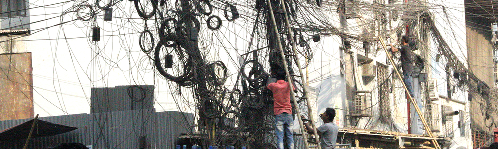 Cables hanging from telephone poles in Bangladesh||||||||||