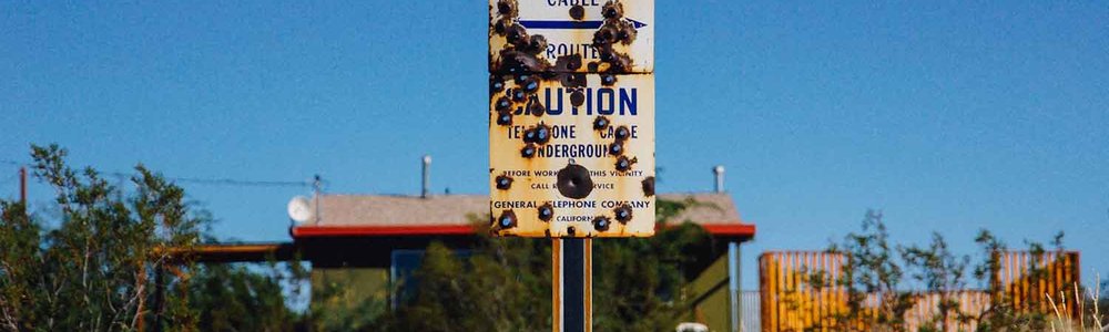 Photo of a sign noting the burial of a telecommunication cable