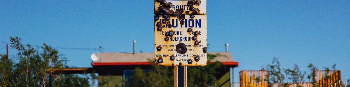 Photo of a sign noting the burial of a telecommunication cable