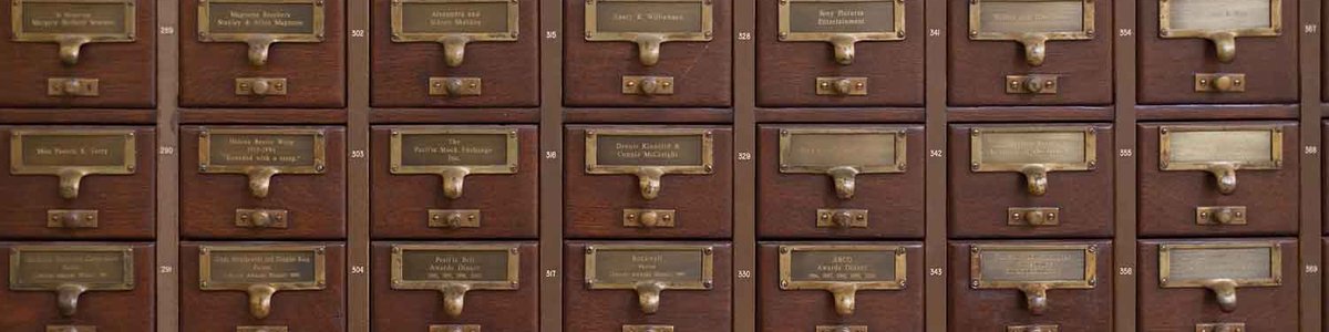 Photo of a stack of card catalog drawers||||