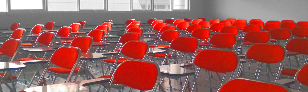 Classroom with red chairs and tables||||||