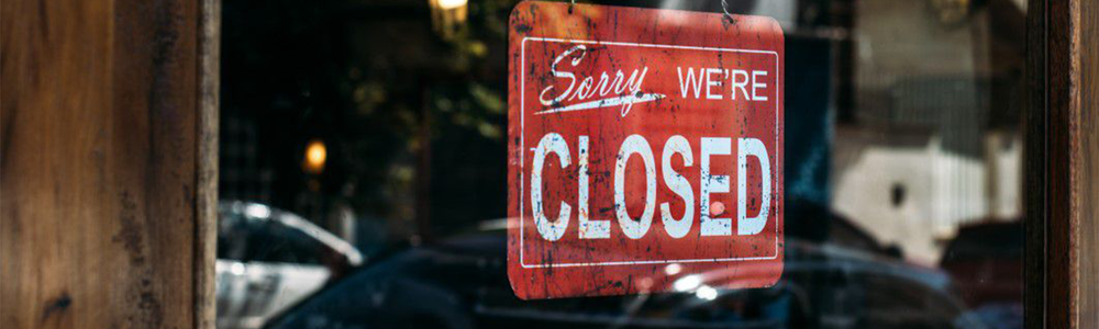 Closed sign hanging in a shop window|