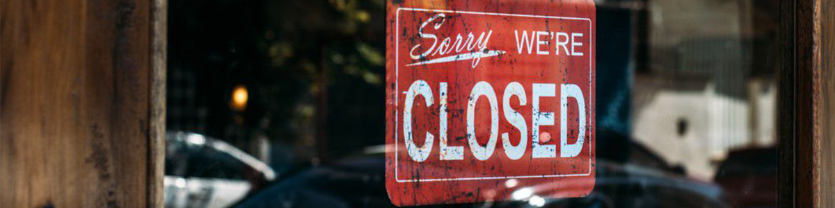Closed sign hanging in a shop window|