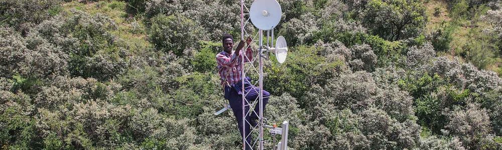 Photo of an engineer standing on a Connectivity Tower at Namelok Community Network, Kajiado West established with the Support of ISOC Kenya Chapter and Help NGO.jpg|||