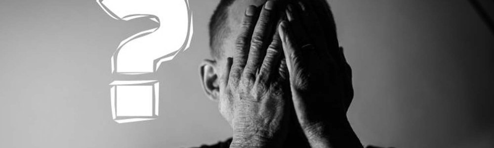 Photo of a man with his head in his hands