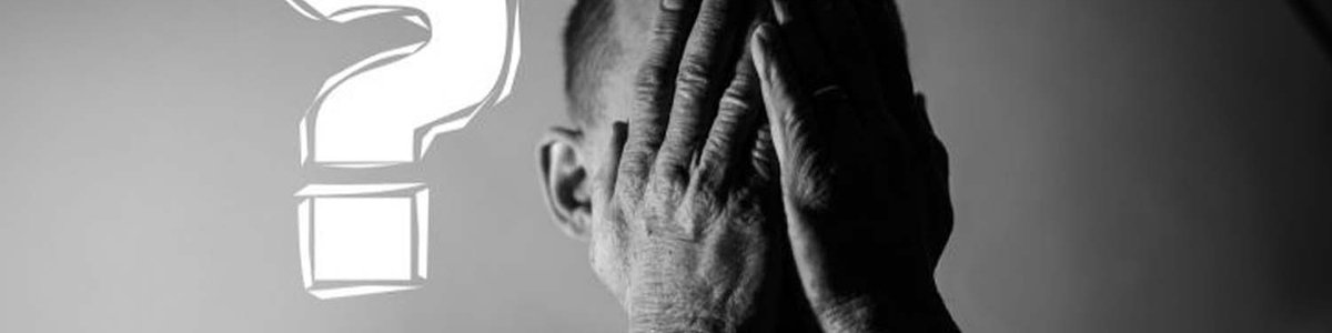 Photo of a man with his head in his hands