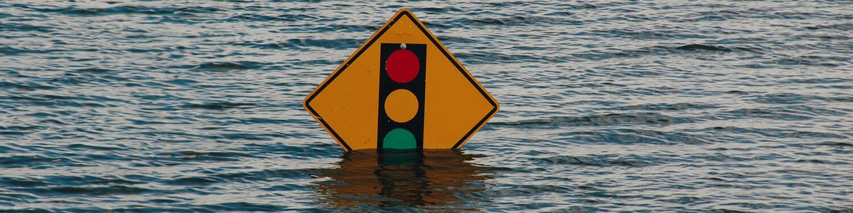 Photo of a road sign almost covered by flood water