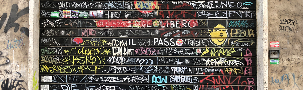 Roller door covered in tags graffiti||||||||||||Tunnel full of graffiti