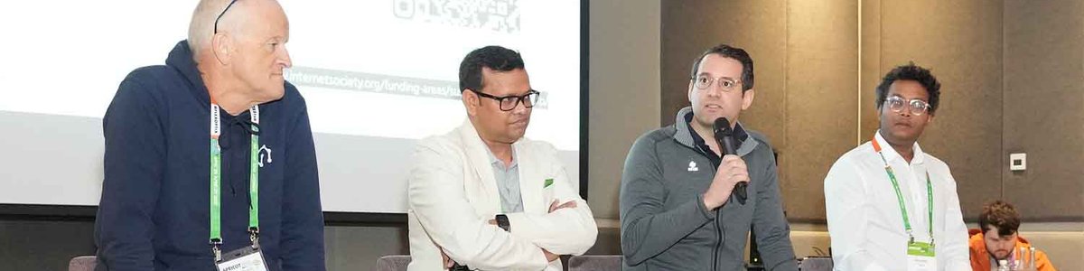 Photo of panelists at APRICOT 2025