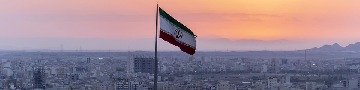 Photo of Iran flag with city in the background|||||