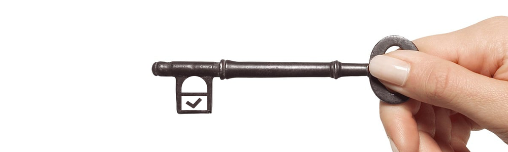 Hand holding a key|||