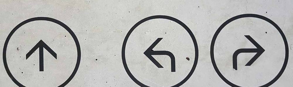 Photo of three arrows pointing in different directions painted on a wall