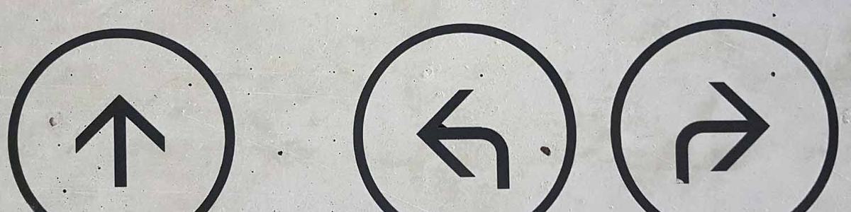 Photo of three arrows pointing in different directions painted on a wall