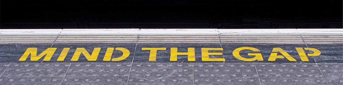 Photo of a station platform showing the words Mind the Gap||