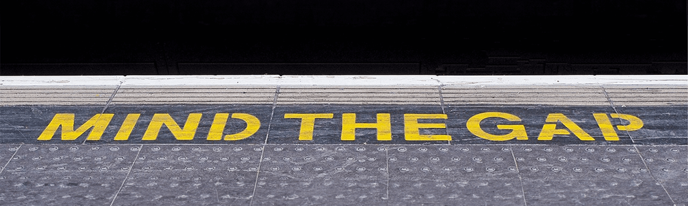 Mind the gap sign on train platform||