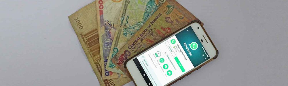 Photo of a smartphone on top of paper money