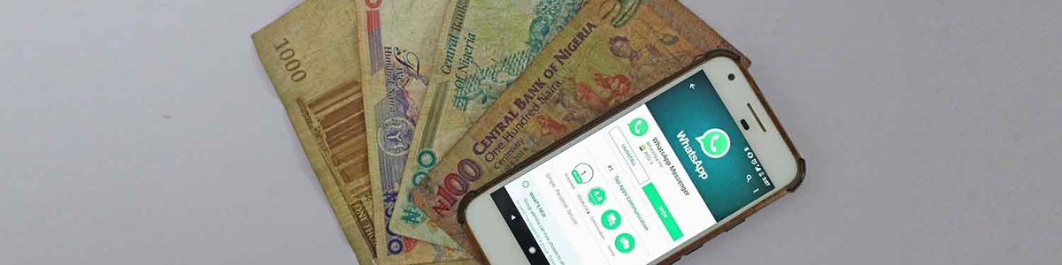 Photo of a smartphone on top of paper money