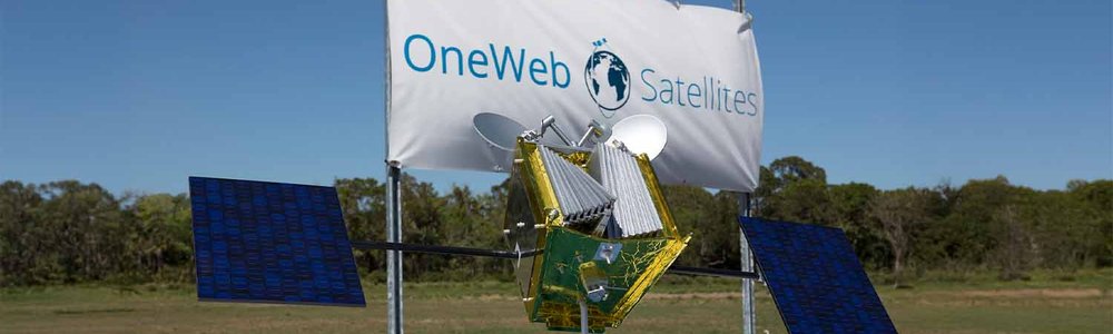 Photo of a OneWeb satellite in front of a OneWeb banner