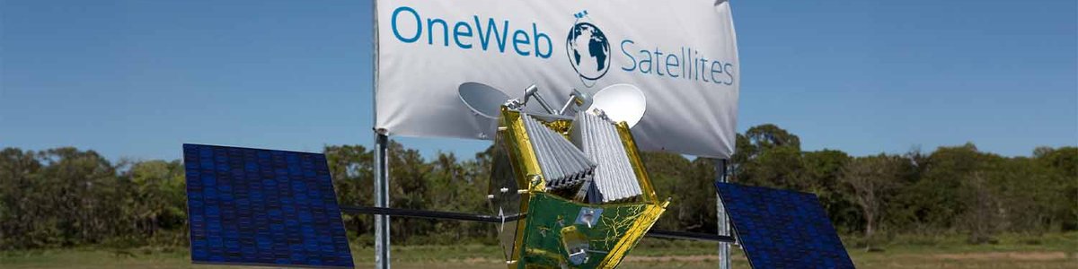 Photo of a OneWeb satellite in front of a OneWeb banner