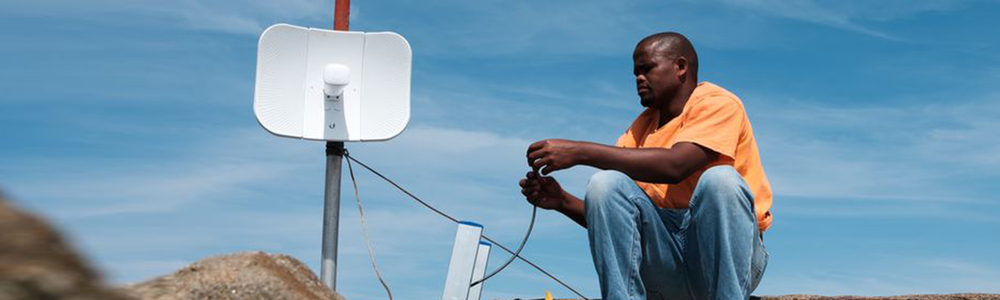 Tomas Sikanisi installing a WiFi antenna at a homestead in the village of Mankosi in the Eastern Cape province of South Africa on 27 September 2018.