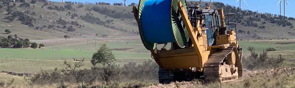 Photo of a fiber cable plow, rolling out cable across farmlands in New South Wales. Image courtesy of AARNET