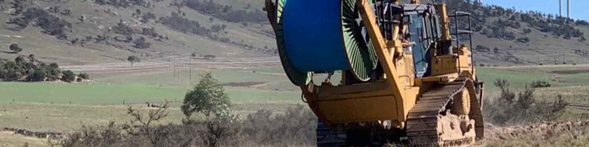 Photo of a fiber cable plow, rolling out cable across farmlands in New South Wales. Image courtesy of AARNET
