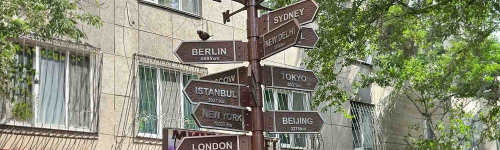Photo of a sign post showing distance to different cities