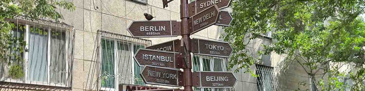 Photo of a sign post showing distance to different cities