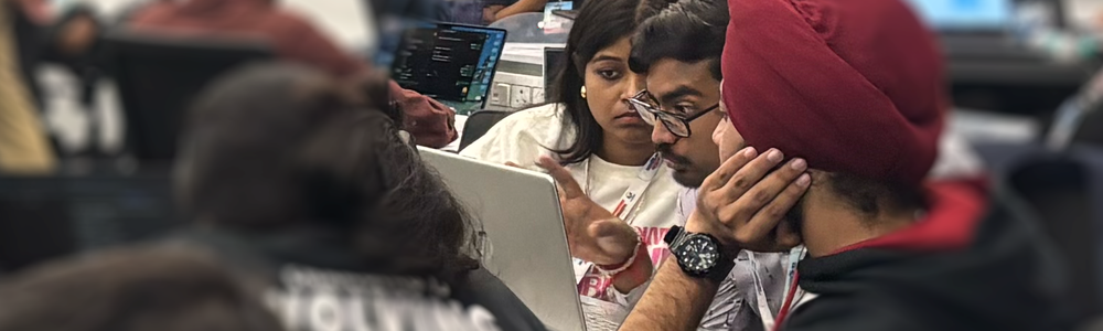 A photo of colleagues conversing about work on a computer