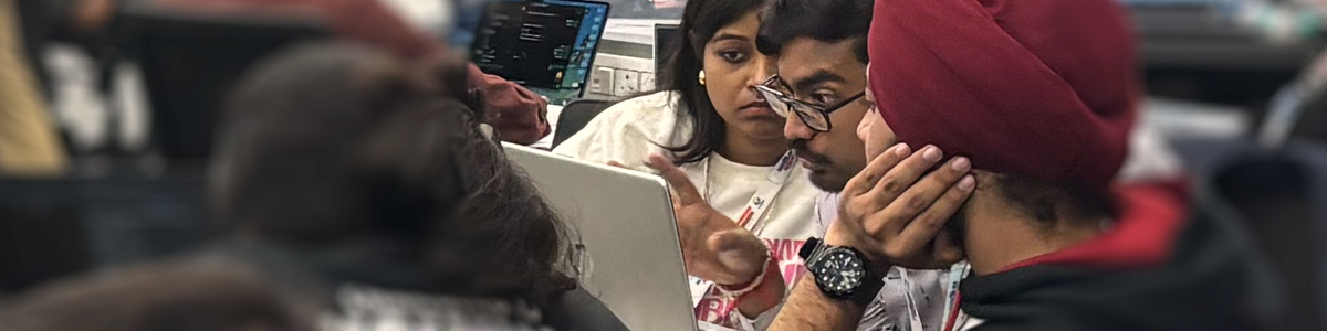 A photo of colleagues conversing about work on a computer