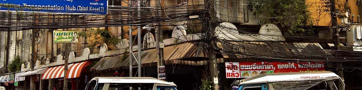 Photo of fiber cables hung up above a street in Thailand.||||||