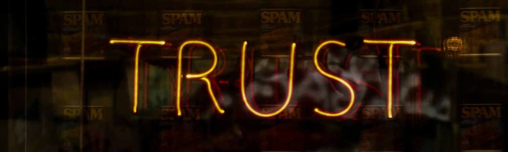 Photo of a neon sign that spells trust||||