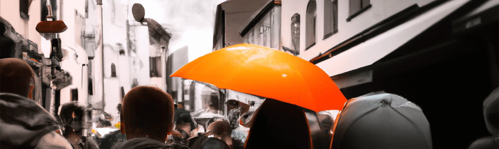 street full of people with one person holding an umbrella||||