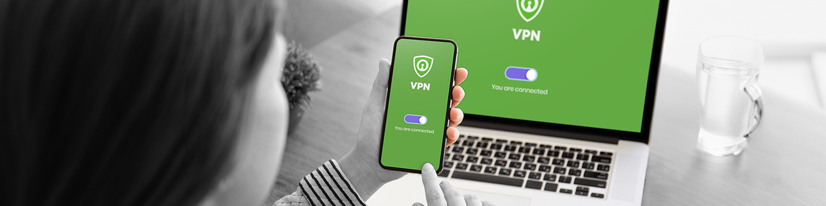 Photo of a lady using a VPN on a mobile and laptop