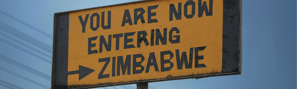Road sign saying 'You are now entering Zimbabwe'|