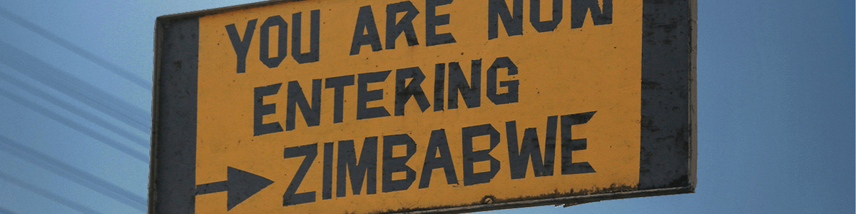Road sign saying 'You are now entering Zimbabwe'|