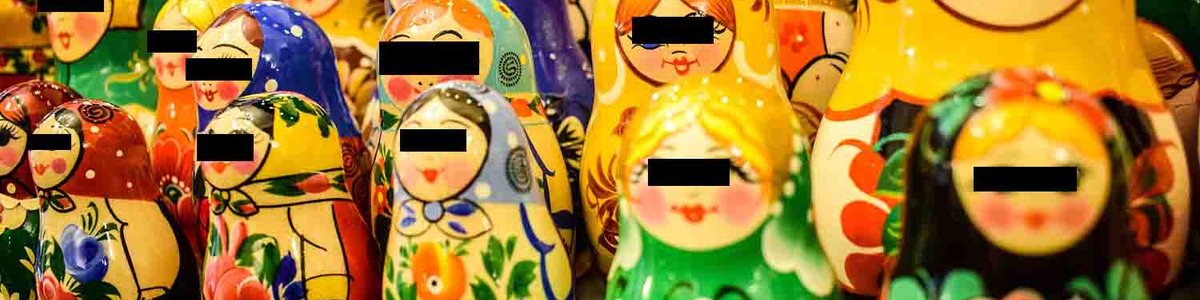 Photo of babushka dolls with black boxes over eyes||||