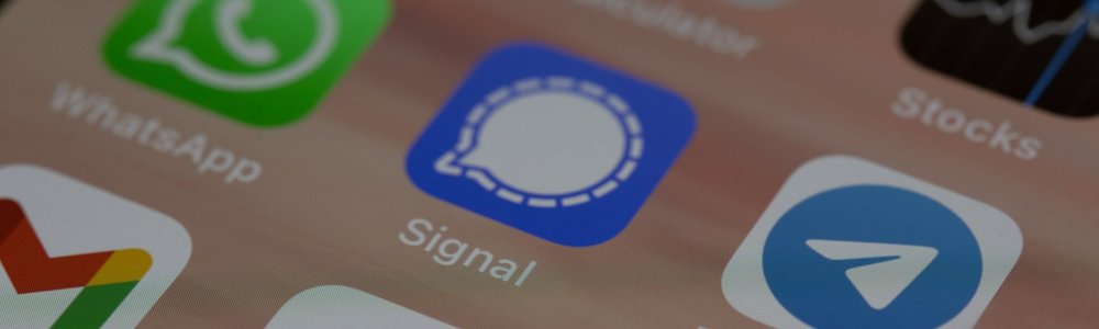 A close up of the screen of a mobile phone showing messaging apps, including Whatsapp, Signal and Telegram|An alert message in French that was shown to Telegram users in error.