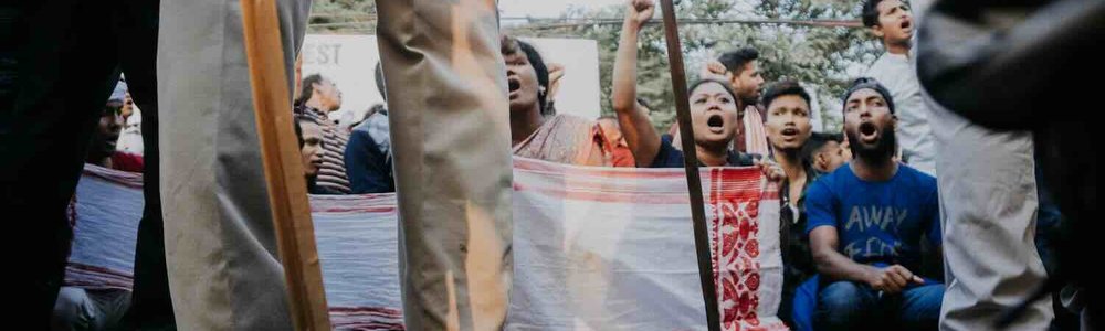 Photo of people of Assam protesting before the police during the CAA protest at Guwahati, Assam