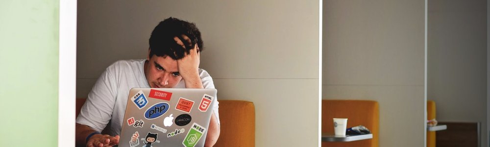 Person work on computer in a library and is frustrated