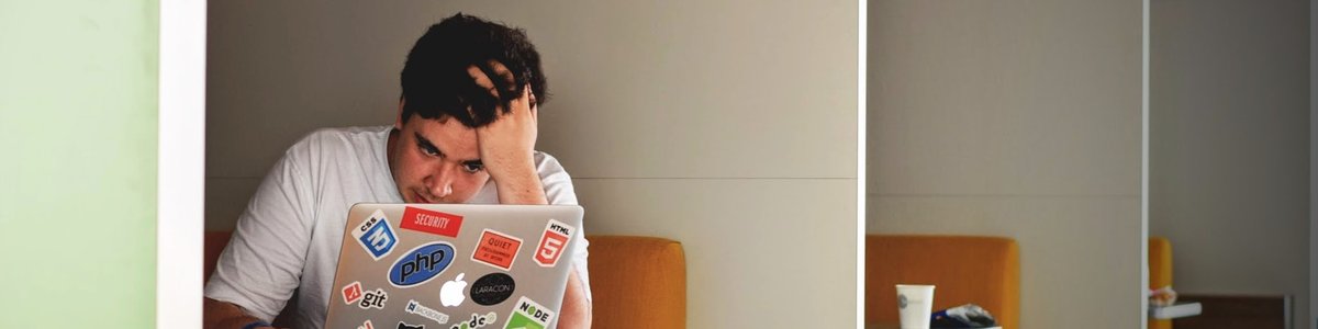 Person work on computer in a library and is frustrated