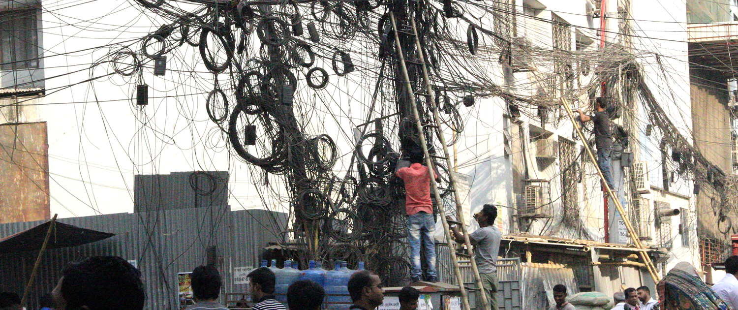 Cables hanging from telephone poles in Bangladesh