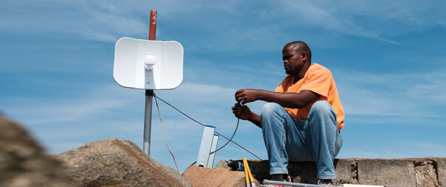 Tomas Sikanisi installing a WiFi antenna at a homestead in the village of Mankosi in the Eastern Cape province of South Africa on 27 September 2018.