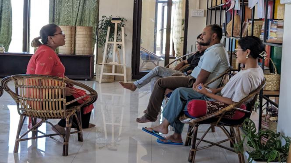 Photo of a group of four people, including Saadia, sitting and discussing the Internet shutdown in Manipur.