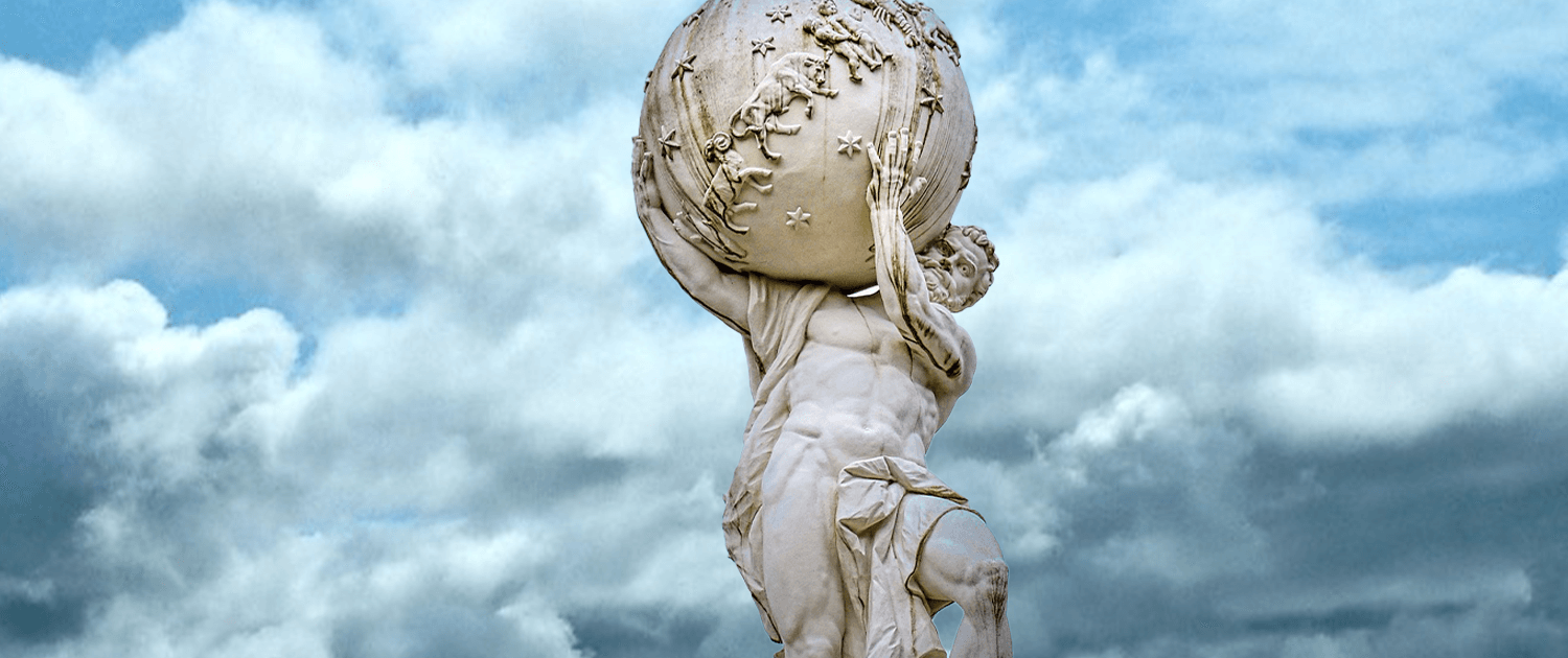 Photo of a statue holding the world on its shoulders.