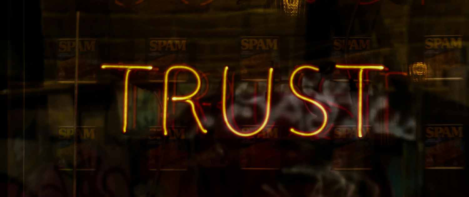 Photo of a neon sign that spells trust