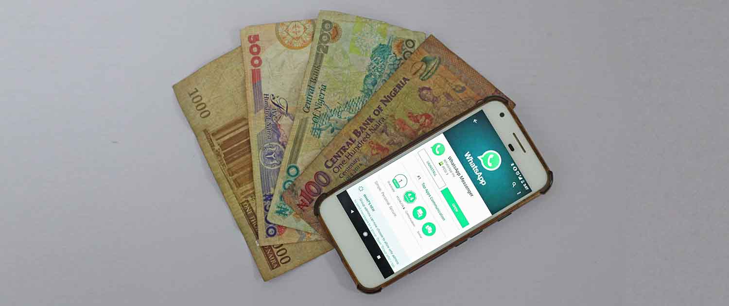 Photo of a smartphone on top of paper money