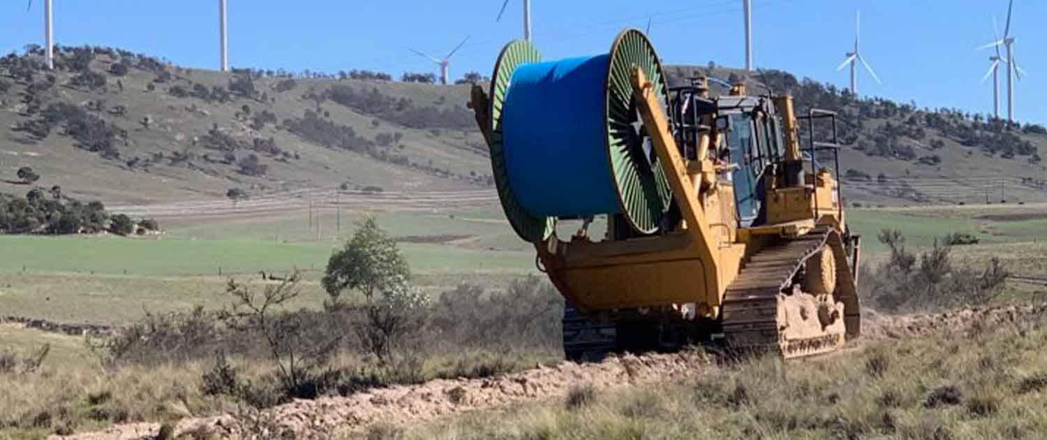 Photo of a fiber cable plow, rolling out cable across farmlands in New South Wales. Image courtesy of AARNET